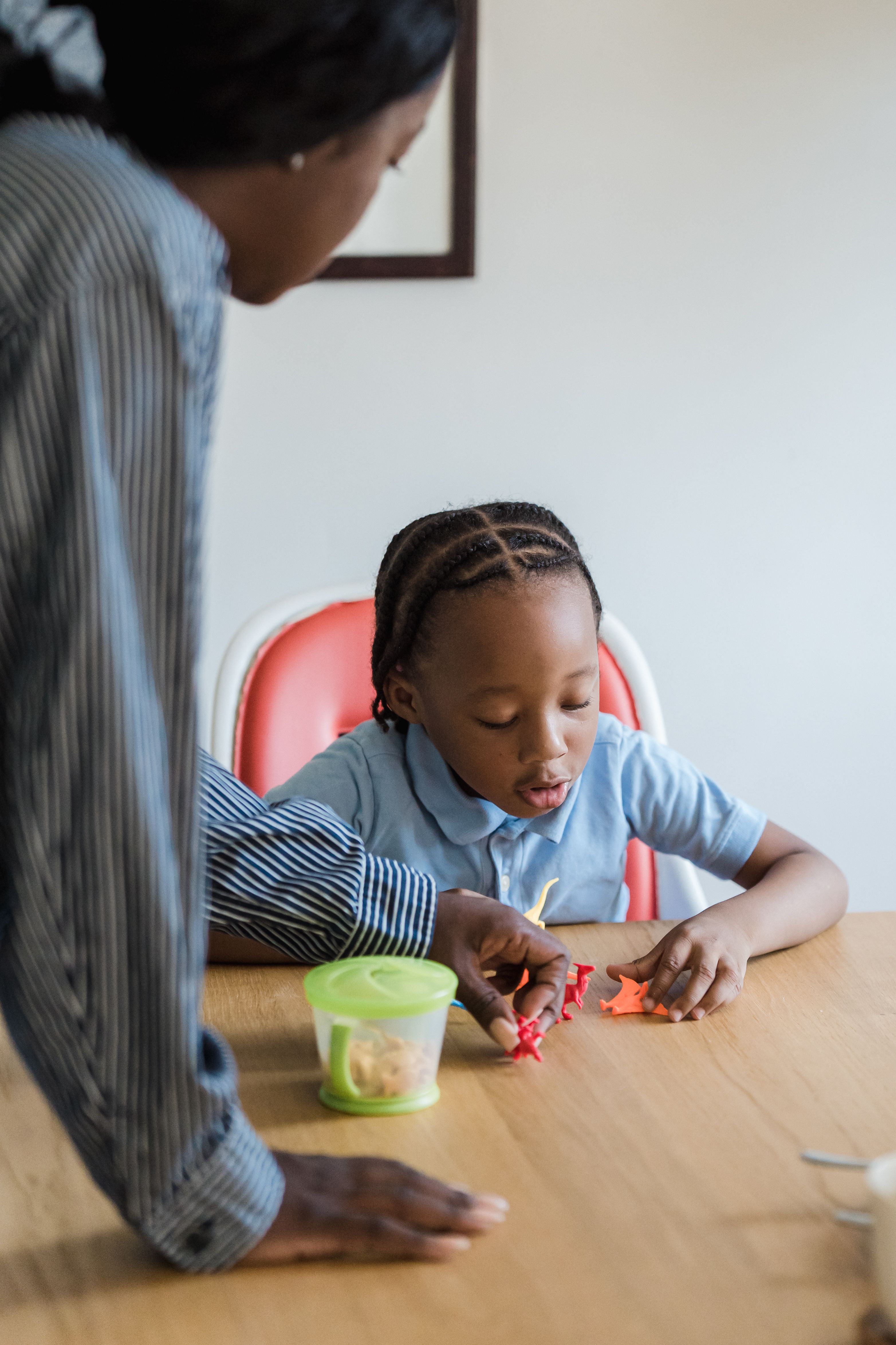 Child engaged in a learning activity with an adult supporting