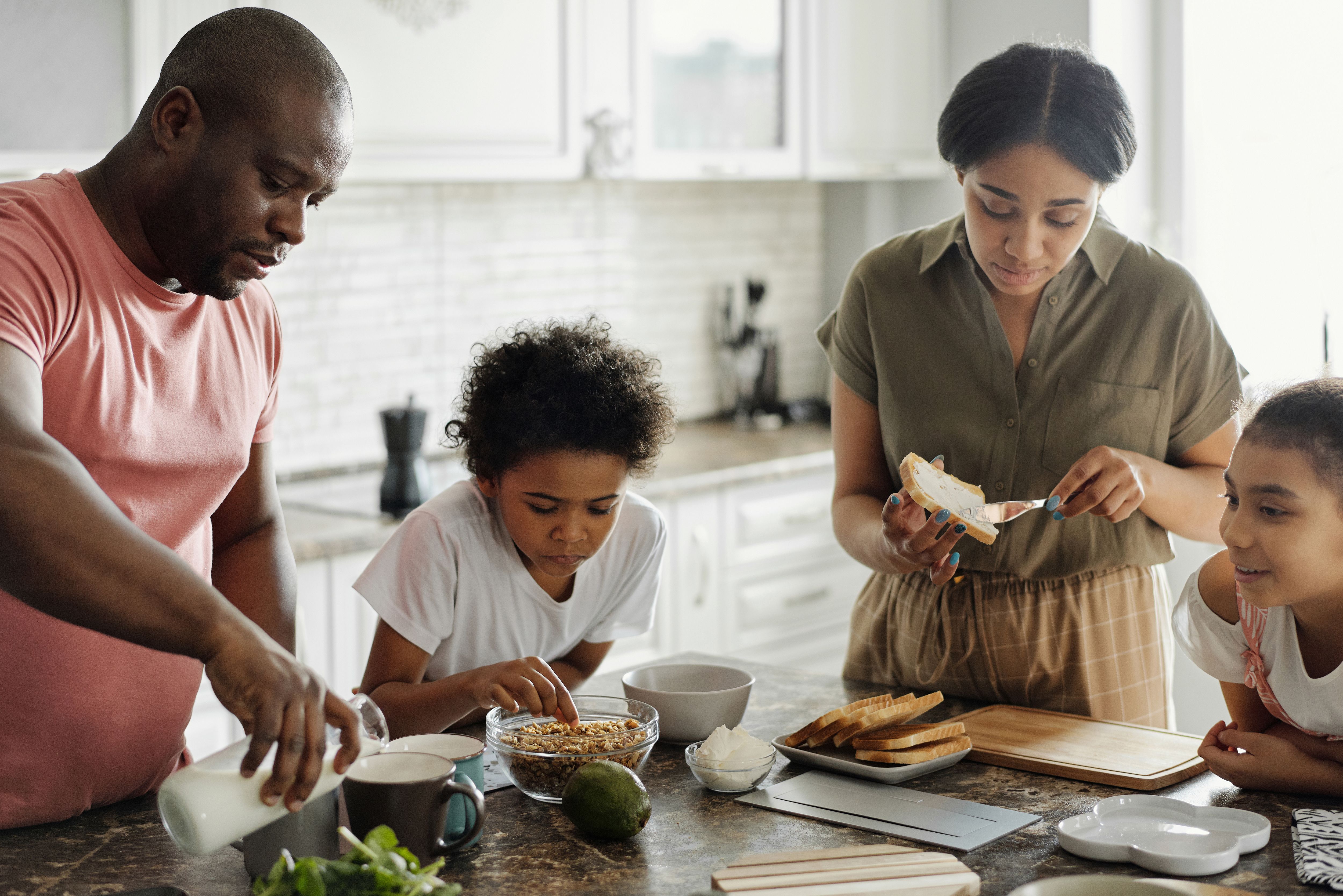 Family preparing breakfast together at the kitchen counter