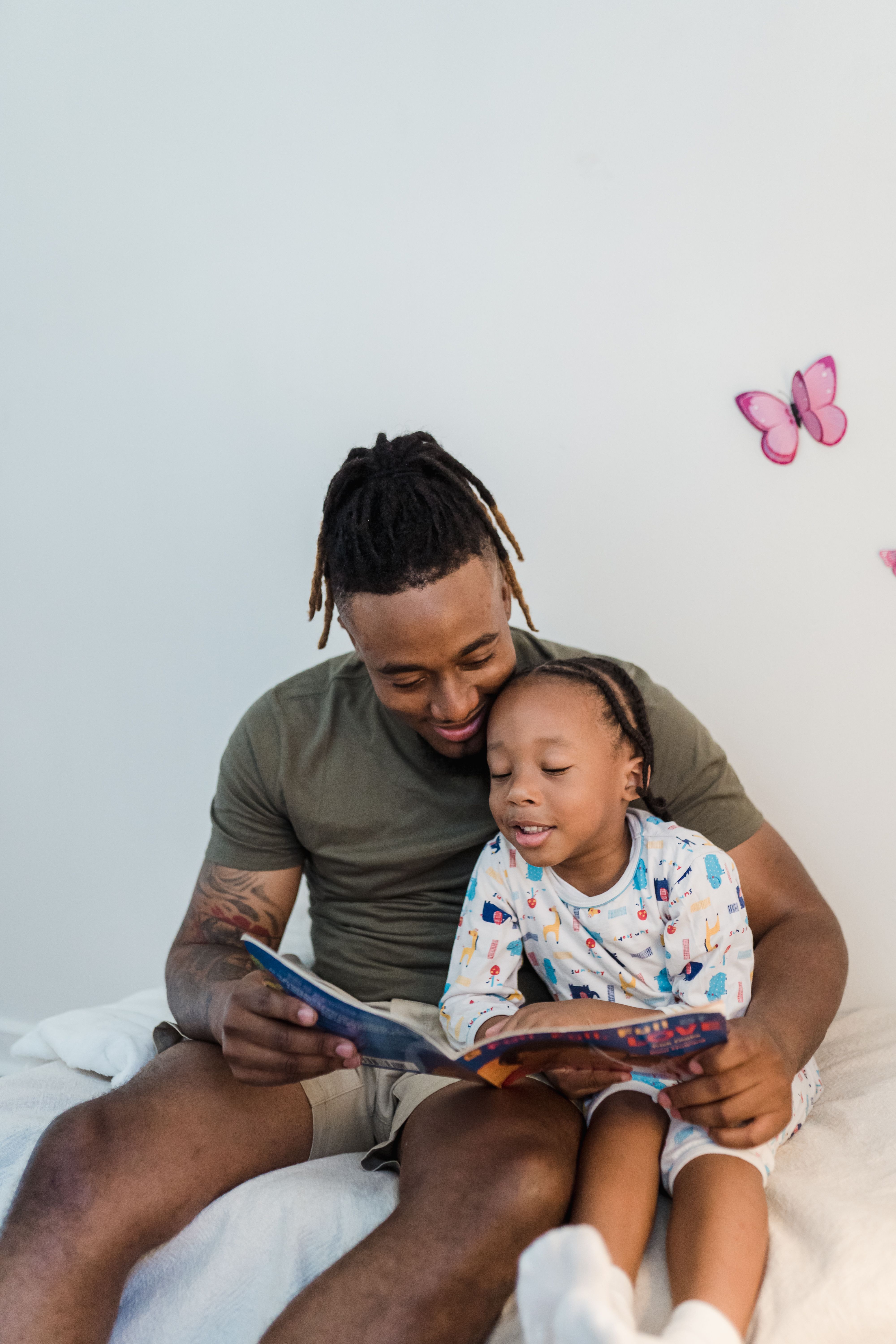 Parent and child reading a book together at home
